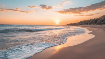 Sunset on a serene beach with gentle waves lapping at the shore during a clear evening