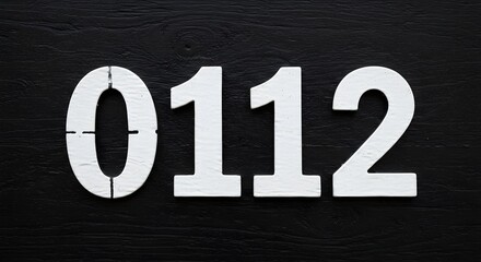 White Number 0112 on Dark Wood Background Graphic Resource