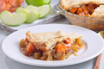 Delicious homemade apple and sweet potato cobbler pie showing filling ingredients, horizontal