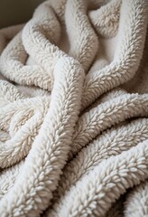 close up of a blanket on a bed