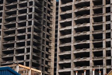 Vertical view of high-rise concrete structure with deep architectural shadows