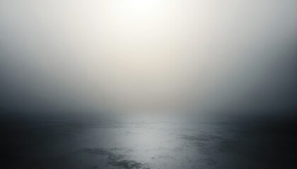 A calm and foggy body of water with an indistinct horizon under soft diffuse light creating a tranquil and mysterious atmosphere
