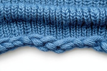 Close-up of a soft blue knitted fabric with detailed cables and ribbing texture conveying warmth and comfort