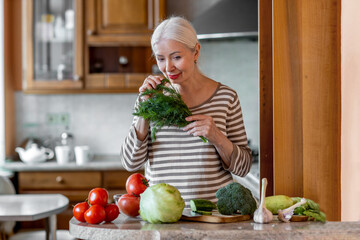 Elderly woman cooking breakfast in the kitchen