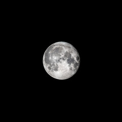 Detailed image of the full moon isolated on black.