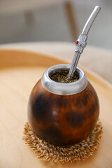 Traditional yerba mate tea on table indoors, closeup