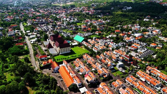 Kuta selatan bali with red rooftops and lush greenery all around, aerial view