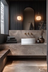 Modern bathroom vanity with round white sink, marble countertop, dark wood walls, soft glowing pendant lights, folded towels, decorative dried branches in vase, and wall mirror