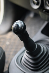 Manual transmission shift selector in the car interior.  Close-up detail of handbrake manual brake...