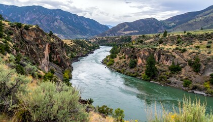 Fototapeta premium Serpentine river carving through a mountain valley. Dramatic landscape photography.