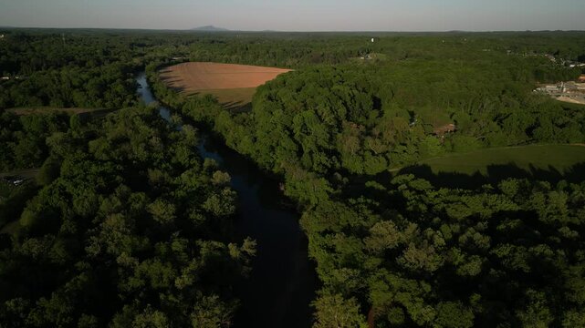 Aerial of Yadkin River and crops in rural Elkin North Carolina at sunset