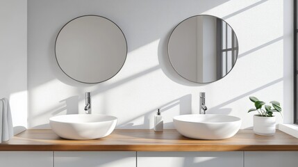 Two round mirrors above a light-colored bathroom vanity.