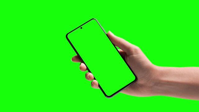 Hand tapping smartphone with green screen display