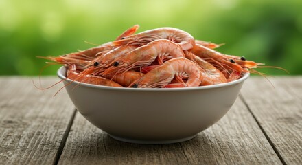 Fresh shrimp in a bowl on a wooden table