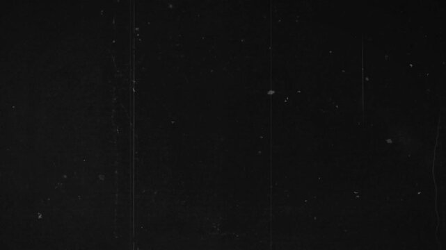 White scratches and roughness on a black screen. Effect of old film noise in 4K with alpha channel.