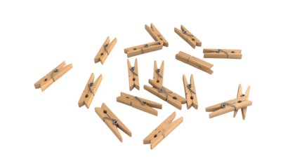 A collection of wooden clothespins is scattered across a white surface.