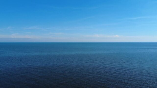 Descending drone view over calm sea in Montevideo