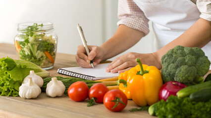 Person planning grocery list for healthy eating