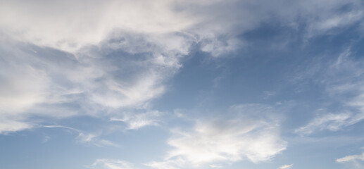 Low angle view and full frame of beautiful blue sky with strange shape of fluffy white clouds in the morning or afternoon  on sunny day used as natural background texture in decorative art work