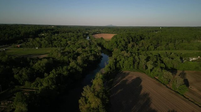 Aerial over crops and Yadkin river in Elkin North Carolina at sunset