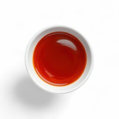 Chili oil in bowl, top view on white background