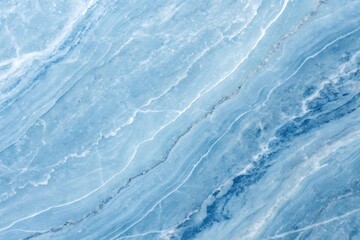 Abstract blue water surface shows a cold winter texture with a cloudy sky reflected on its frozen pattern