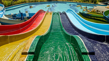 Colorful slides at the water park. Water play rides. Summer time.