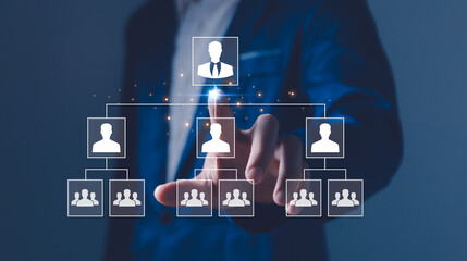 Businessman point a glowing digital organizational chart, leadership and team structure. Manager...
