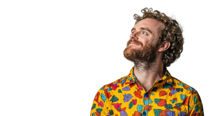 Png of Thoughtful young man with curly hair and a colorful shirt, gazing upward with a slight smile.