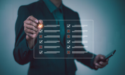 Businessman checklist concept as clipboard document checklist form on the virtual screen Use your hands or a pen to check the correct control gaps and check the quality standards of the work.	
