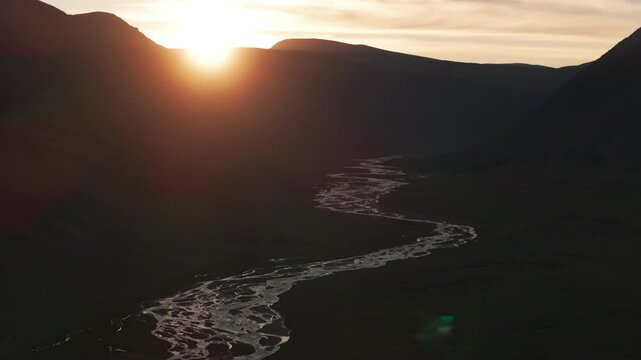 Aerial view of Tsagaan Gol Valley and river at sunset, showcasing the stunning landscape of Mongolia&rsquo;s rugged terrain in Asia