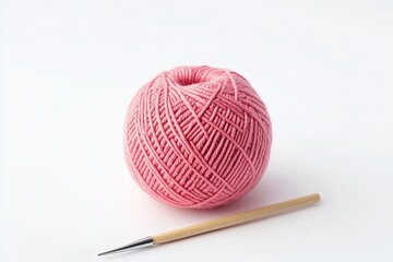  A pink ball of yarn and a crochet hook on a white background, a simple studio shot in a minimalist style, high-resolution photography, detailed imagery.