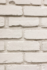 A close-up of a brick wall that has been painted white