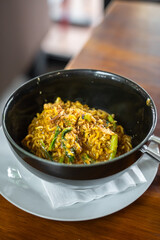 Spicy Bangladeshi noodles in a black bowl. A delicious food typical of Medan, North Sumatra. (Mie Bangladesh)