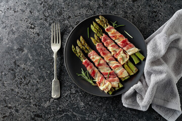Grilled green asparagus wrapped in bacon.