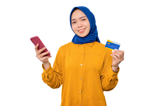 Confused young Asian Muslim woman dressed in orange shirt holding mobile phone and credit card isolated on transparent background