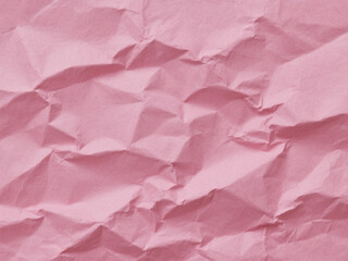 Fototapeta premium Crumpled pink paper texture. Pink wallpaper background 