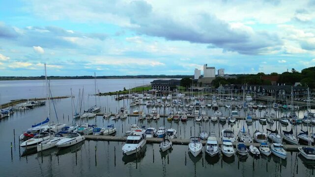 Skive yacht harbor in Skive, Denmark, Europe. Harbor with Wooden Pier and Sailing Ships. Beautiful view. Boats moored in Maarup Havn, Samsoe, Jutland, Denmark. View from above. Drone. Sailboats.