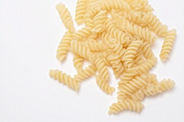Cooked fusilli pasta scattered on white background
