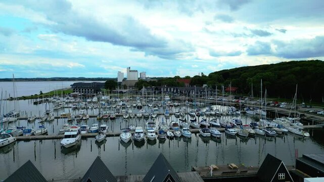 Skive yacht harbor in Skive, Denmark, Europe. Harbor with Wooden Pier and Sailing Ships. Beautiful view. Boats moored in Maarup Havn, Samsoe, Jutland, Denmark. View from above. Drone. Sailboats.