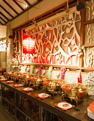 Warm-lit Buffet Line with Intricate Wooden Wall Decor