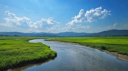 A rural countryside scene with a river that reflects the clear sky, surrounded by vibrant green fields and distant hills, now brightened after the rain.