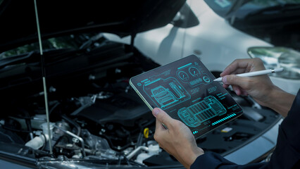 Auto mechanics are checking engines using modern technology, maintaining cars and repairing cars in...