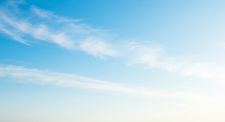 Obraz premium Delicate wisps drift across a pastel azure canvas creating a serene vista