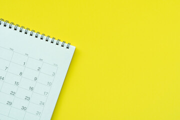close up of calendar on the yellow table background, planning for business meeting or travel planning concept