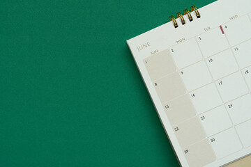 close up of calendar on the green table background, planning for business meeting or travel planning concept