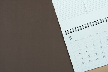 close up of calendar on the brown table background, planning for business meeting or travel planning concept