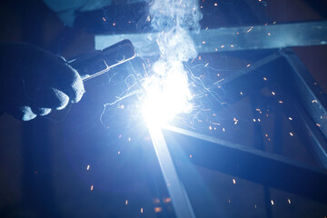 A person is welding metal with a torch