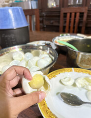 Hand Peeling Hard-Boiled Egg, Golden Yolk Visible, Rustic Kitchen Setting