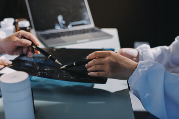 Male and female doctors are having a meeting in a hospital room.
